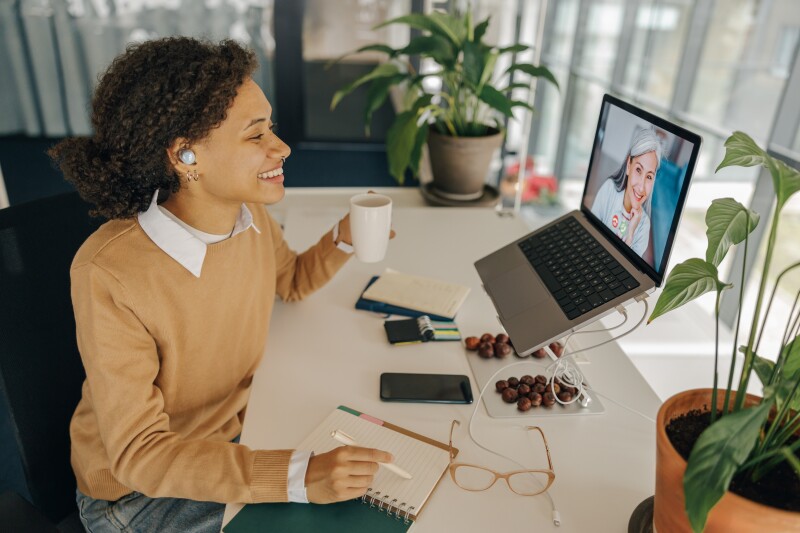 woman having conversation with client over video conferencing